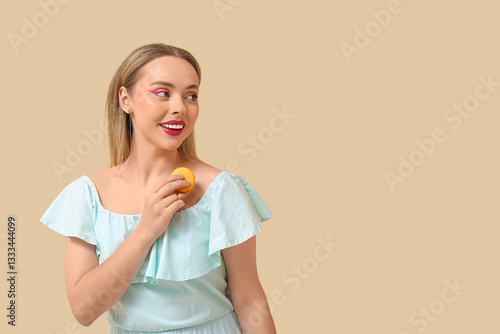 Happy young woman with oran...