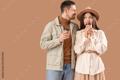 Young couple with cups of c...