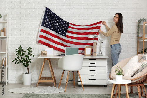 Young woman hanging USA fla...
