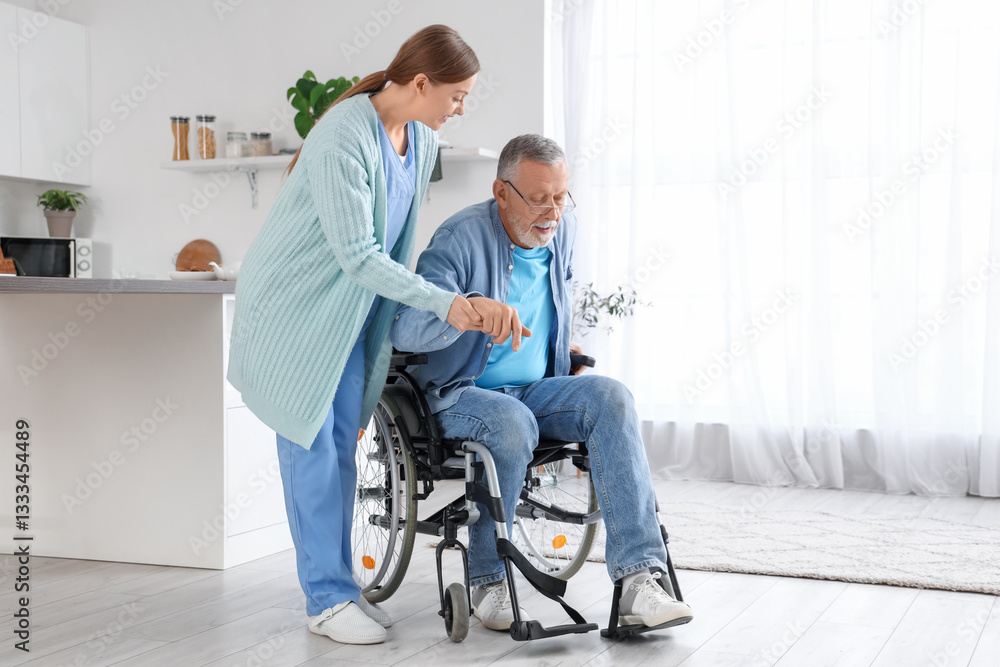 Female caregiver helping senior man in wheelchair at nursing home Female caregiver helping senior man in wheelchair at nursing home