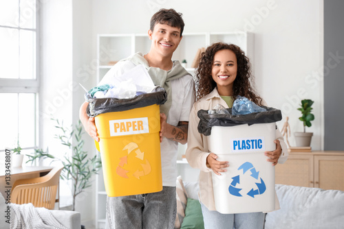 Young couple with garbage c...
