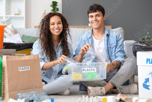 Young couple throwing plast...