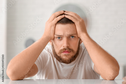 Worried young man with hair...
