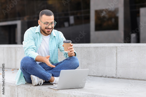 Young man with laptop video...