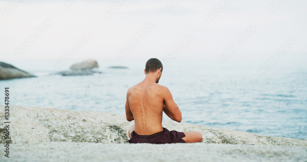 Man, yoga and back by beach with meditation, peace and mindfulness on rock in morning for wellness. Person, breathing space and self care routine with zen, chakra and water by ocean in New Zealand Man, yoga and back by beach with meditation, peace and mindfulness on rock in morning for wellness. Person, breathing space and self care routine with zen, chakra and water by ocean in New Zealand