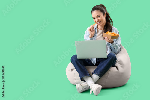 Smiling young woman eating ...