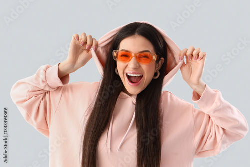 Stylish young woman in pink...