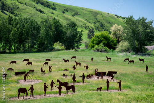 Wallpaper Mural An artistic representation of horses and people in a lush green pasture, reflecting themes of community, connection, and the beauty of rural life in a vibrant setting. Torontodigital.ca