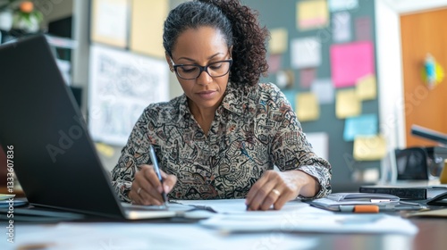 A business owner reviewing financial documents and reports on a desk. photo