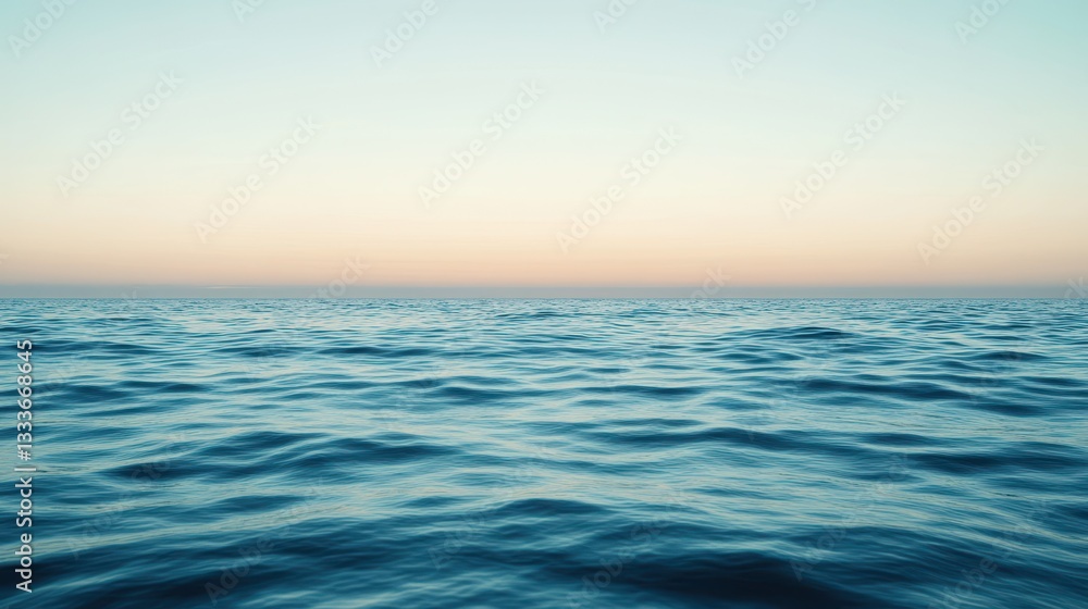 Obraz premium Gentle ocean waves ripple beneath a calm, clear sky, creating a serene and tranquil seascape.