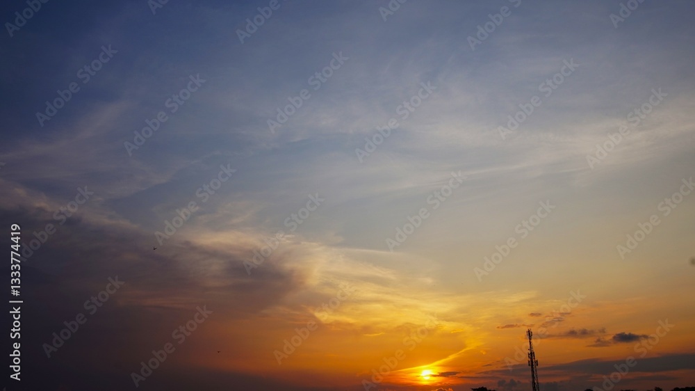 Fototapeta premium sunset and evening sky with yellow clouds highlighted by the sun, black clouds combined with sunlight create a dramatic sky atmosphere