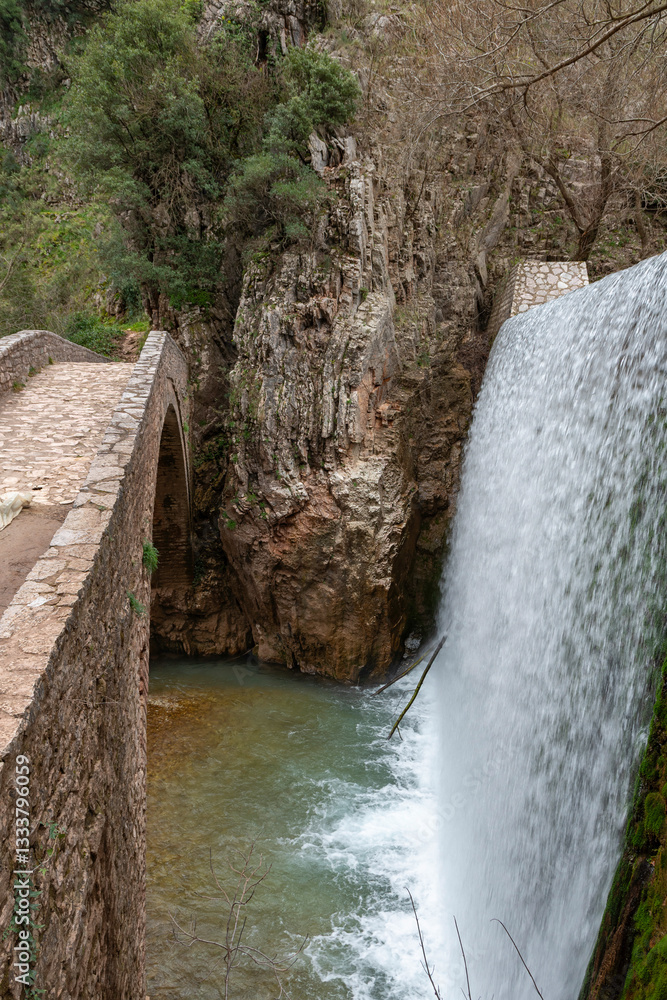 Palaiokarya stone arched bridge and waterfall near Pyli village, Thessaly, Greece