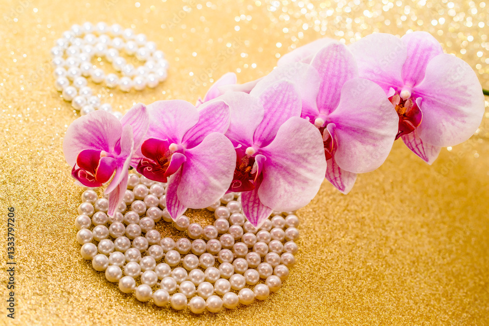 A branch of purple orchids on a shiny gold background
A branch of purple orchids on a shiny gold background