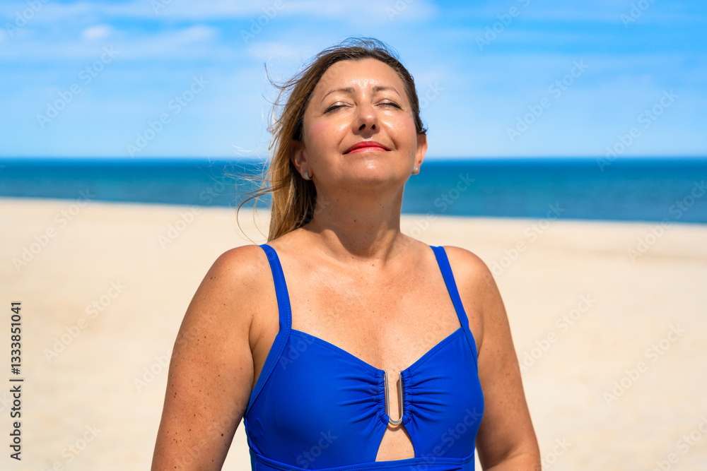 Portrait of beautiful relaxed middle aged woman exposing to sun against beach background. Relaxation on summer holidays Portrait of beautiful relaxed middle aged woman exposing to sun against beach background. Relaxation on summer holidays