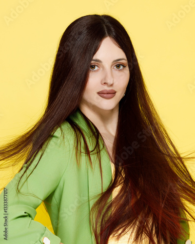 Obraz na płótnie Fashion portrait of beautiful model in green suit against yellow background w salonie
