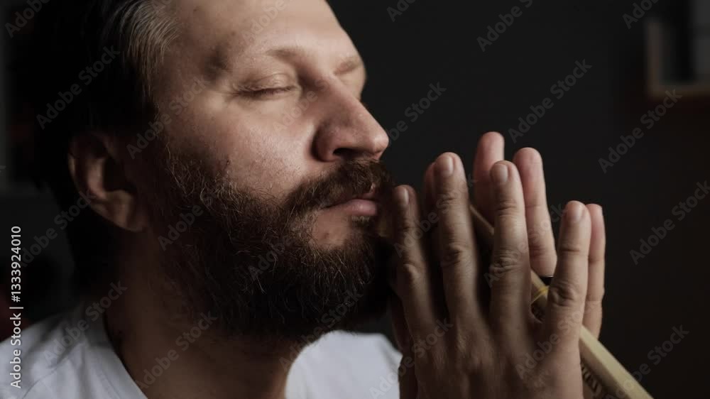 Income, earnings, bribe concept. Happy bearded man in home office looks at wad of money, counts and sniffs it, rejoices. Close-up Income, earnings, bribe concept. Happy bearded man in home office looks at wad of money, counts and sniffs it, rejoices. Close-up