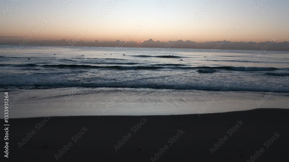 custom made wallpaper toronto digital Aerial Dawn Over the Coast: Rolling Waves, Surfers, and the Sun Emerging from Behind Clouds on the Horizon.