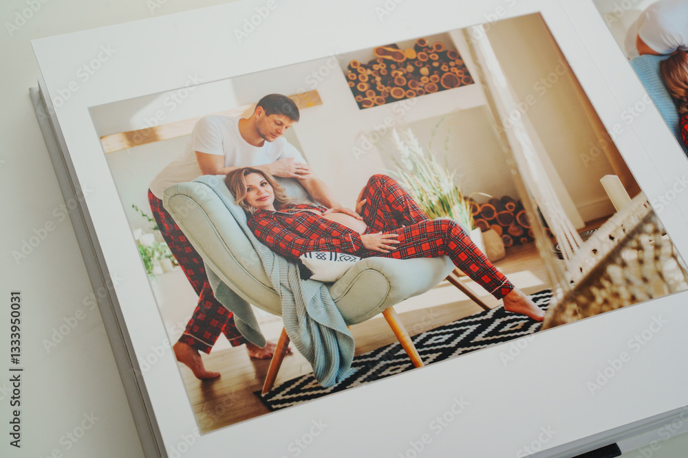 The pages of a photo book with color photos of a pregnant blonde and a man.
