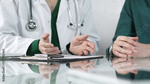 Doctor using hand gestures to explain diagnosis to patient during medical consultation, providing support and guidance for healthcare decisions