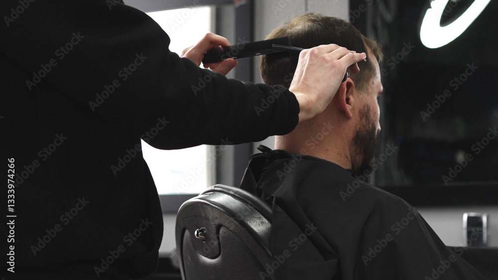 Skilled barber trimming client's hair using professional scissors, creating precise hairstyle in contemporary salon with modern interior and relaxed atmosphere, closeup