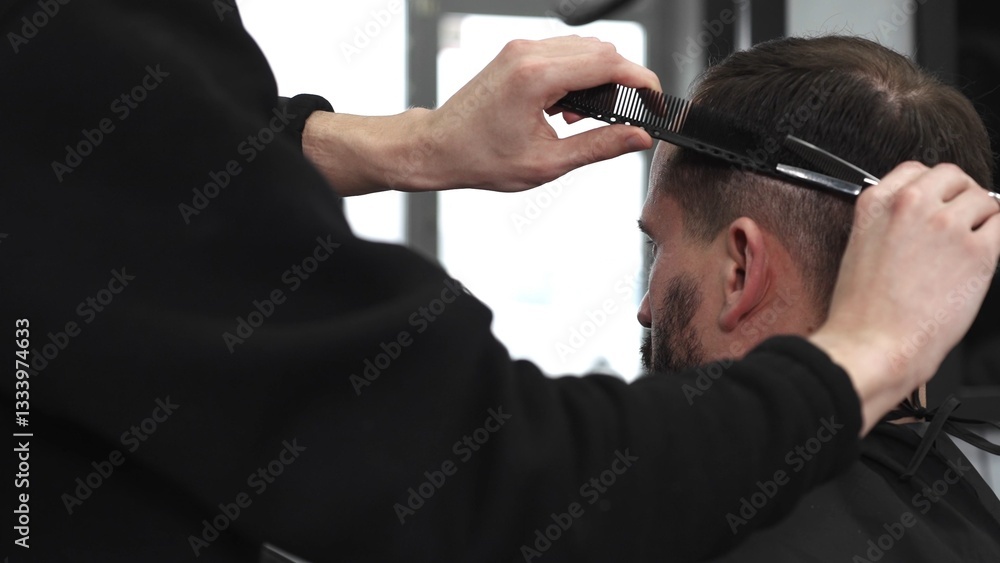 Skilled barber trimming client's hair using professional scissors, creating precise hairstyle in contemporary salon with modern interior and relaxed atmosphere