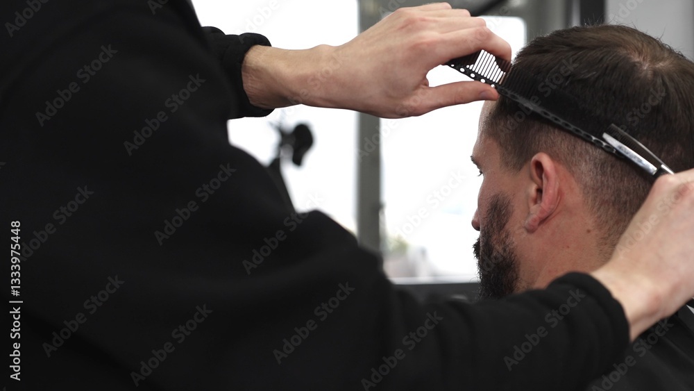 Skilled barber trimming client's hair using professional scissors, creating precise hairstyle in contemporary salon with modern interior and relaxed atmosphere