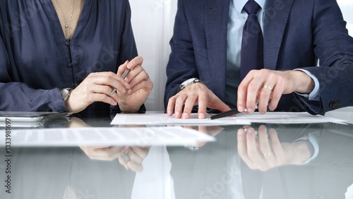 Obraz na płótnie Business partners or lawyers are reviewing contract terms during a meeting, negotiating and making decisions together. Business people concept, close up view w salonie