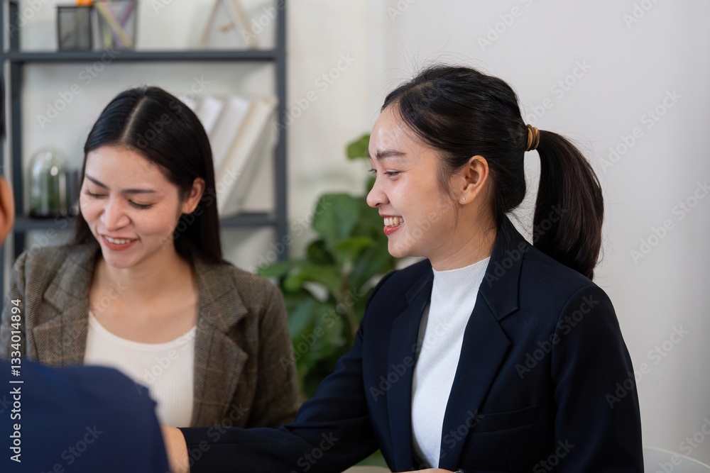 Collaboration and Business Strategy. Two professional women engaging in a discussion over a project in a modern office environment. Collaboration and Business Strategy. Two professional women engaging in a discussion over a project in a modern office environment.