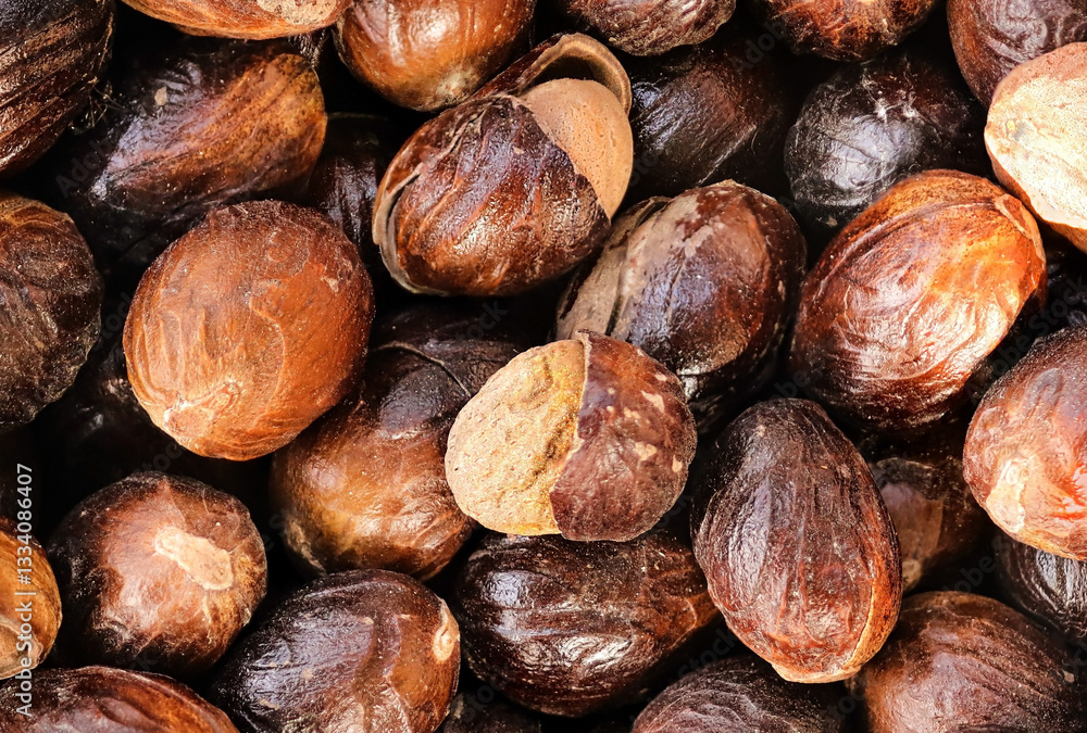 selective focus. some Nutmeg or Jaiphal is an aromatic spice. Also Known as Myristica Fragrans. Closeup of Organic nutmeg seed. (Javitri). Indian Aromatic Spice. Top view. food background
