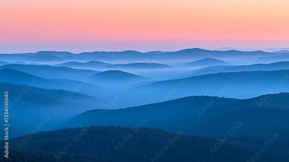 A misty mountain range with layers of hills fading into the distance, bathed in the soft light of dawn A misty mountain range with layers of hills fading into the distance, bathed in the soft light of dawn