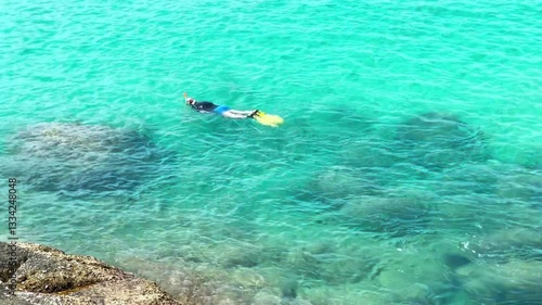 Tourist Snorkeling in Crystal Clear Waters of Phuket Shoreline, Thailand