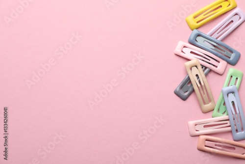Картината върху платно Different hair clips on pink background, flat lay. Space for text