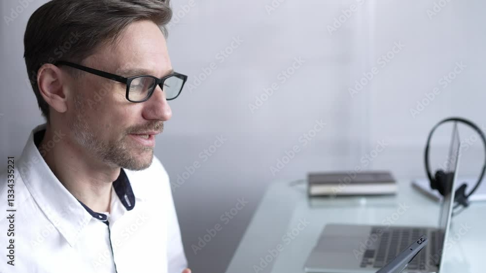Businessman office worker attending online meeting using laptop and microphone, working remotely from home or office. Businesspeople concept Businessman office worker attending online meeting using laptop and microphone, working remotely from home or office. Businesspeople concept