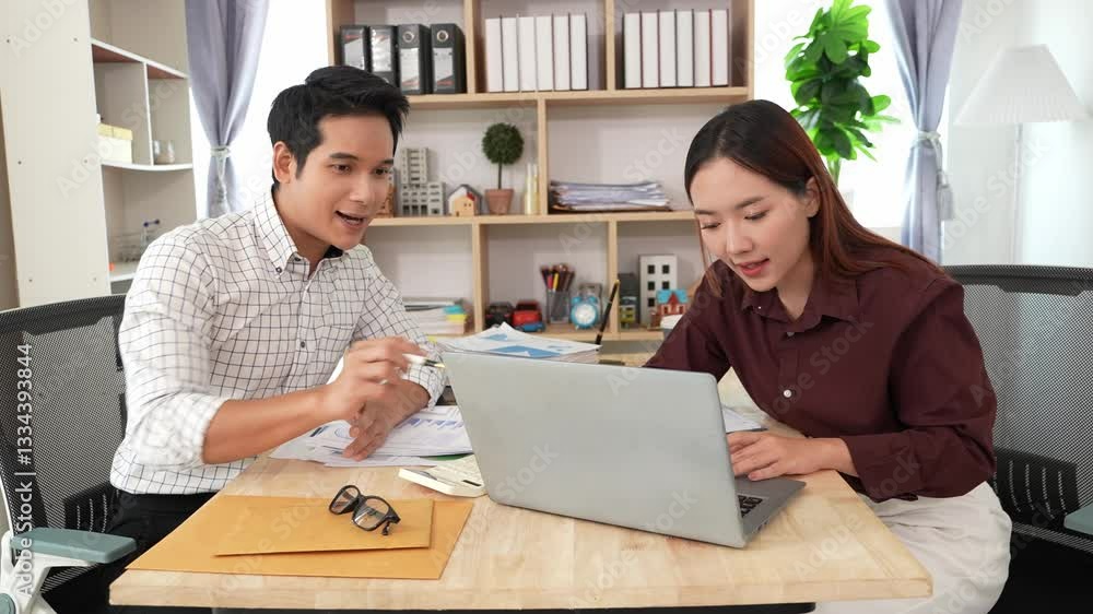 Image of two businessmen and women reviewing and analyzing financial chart data of increasing sales, revenue and profit during meeting in home conference room. Image of two businessmen and women reviewing and analyzing financial chart data of increasing sales, revenue and profit during meeting in home conference room.