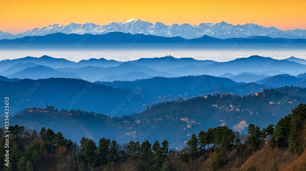 Obraz premium Mountain range view with snow capped peaks and layers of hills under a golden sky light
