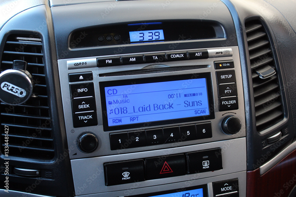 Old car multimedia system on dashboard. SUV control panel. Classic Vehicle Conditioner and climate control. Radio on control panel system in car. Multimedia control system. Old car multimedia system on dashboard. SUV control panel. Classic Vehicle Conditioner and climate control. Radio on control panel system in car. Multimedia control system.
