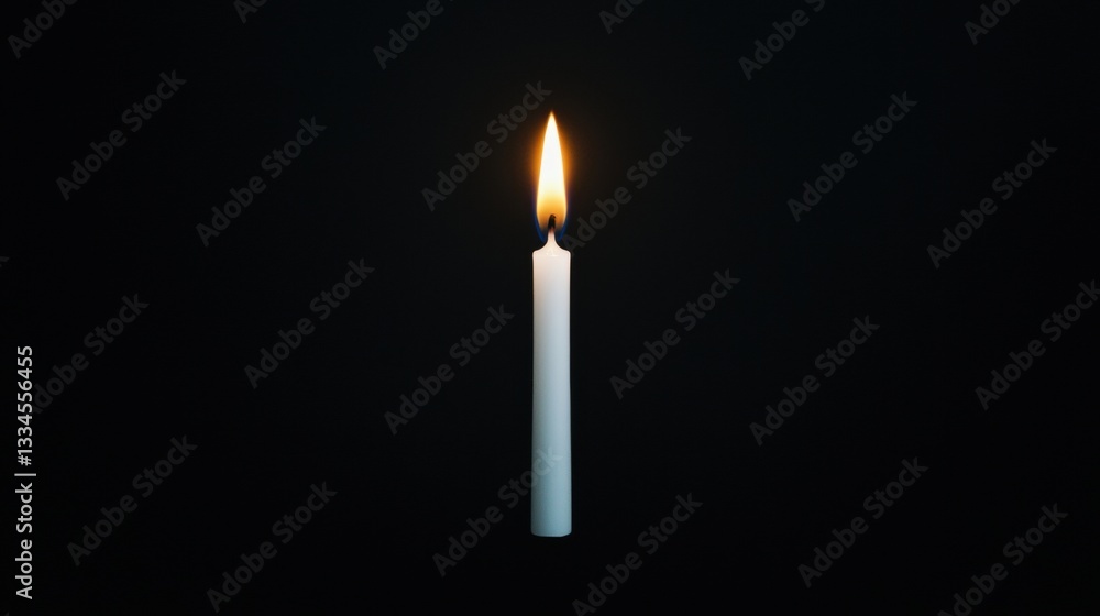 A single white candle with a flickering flame against a black background. A single white candle with a flickering flame against a black background.