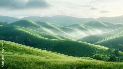 Lush green hills under soft morning light with mist in the valleys captured at sunrise in a serene landscape