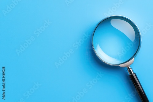 Wallpaper Mural A close-up of a magnifying glass on a blue background, perfect for analysis and focus. Torontodigital.ca