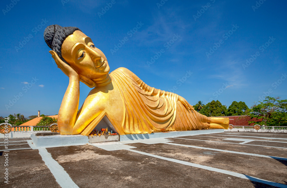 Lying golden Buddha statue in Wat Sri Sunthon temple on Phuket in Thailand. Gilded Buddha statue in Phuket, Thailand. Famous tourist place in Phuket.