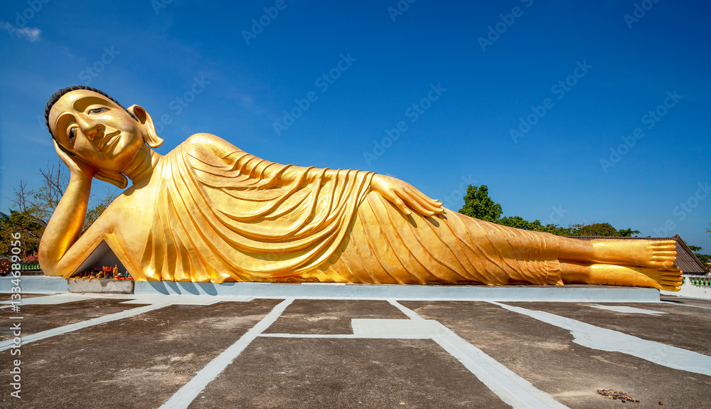 Lying golden Buddha statue in Wat Sri Sunthon temple on Phuket in Thailand. Gilded Buddha statue in Phuket, Thailand. Famous tourist place in Phuket.