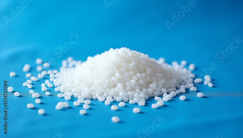 Small plastic pellets on blue cloth. Microplastic. concept as A close up shot of microplastics scattered on a blue cloth representing pollution and environmental issues related to plastic waste. in  P