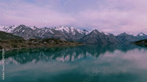 Wallpaper Mural Serene lake with snow-capped mountains under pink sky at dusk, tranquil nature scene Torontodigital.ca