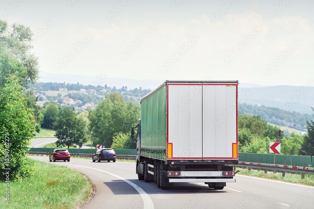 Cargo truck driving on rural highway road
