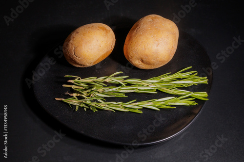Fresh potatoes with rosemary sprigs for cooking