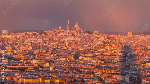 4K timelapse of Paris panorama during sunset golden hours, with clouds moving, dramatic light changing and sun rays walking over reaching the Sacre Coeur Basilica in the distance, skyline of Paris