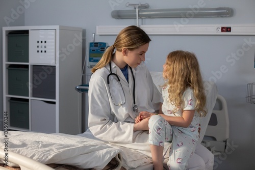 A caring doctor interacts warmly with a young patient in a hospital, providing support