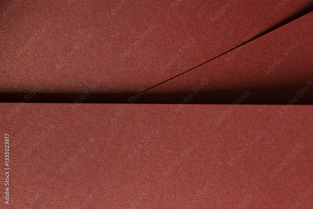 Fototapeta premium Burgundy paper background with a smooth texture and a metallic, glossy finish. Rich, warm tones create an elegant, luxurious design, perfect for premium stationery and sophisticated, modern artistic.