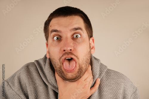 фотографія The discomfort on his face shows the urgency of the moment, as he struggles with breathing or a strong cough