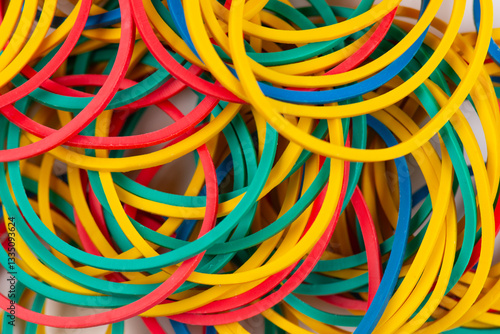Many colorful rubber bands on a white background. Abstract background of seamless lines.